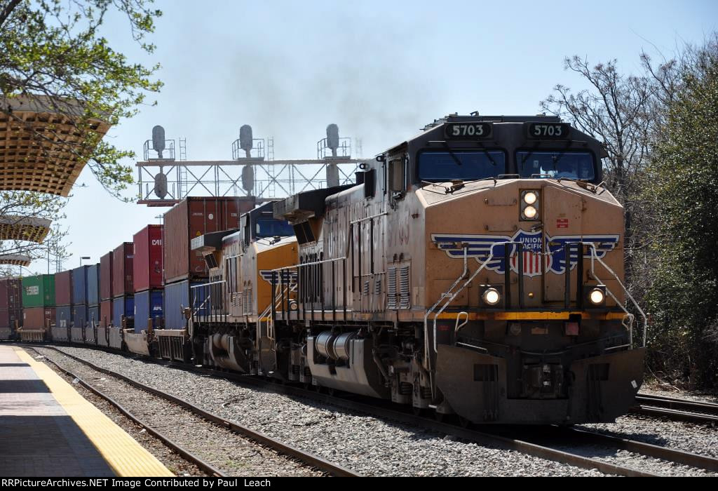 Stack train rolls west past the station